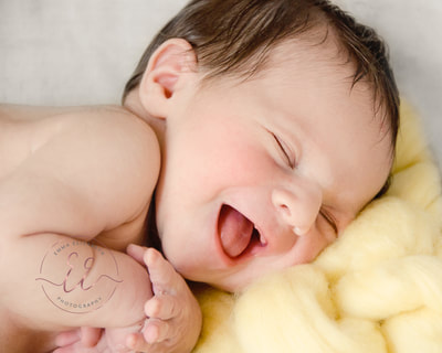 happy smiling newborn baby. Newborn photography in St Neots, Huntingdon, Cambridgeshire