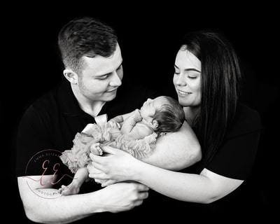 Black and white high key family portrait. Newborn photography in St Neots, Huntingdon, Cambridgeshire