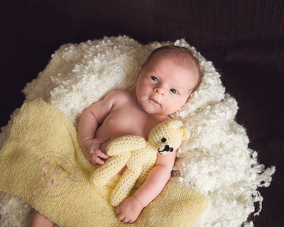 Happy baby in yellow. Newborn photography in St Neots, Huntingdon, Cambridgeshire