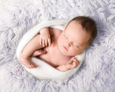 Baby girl in lilac flokati. Newborn photography in St Neots, Huntingdon, Cambridgeshire