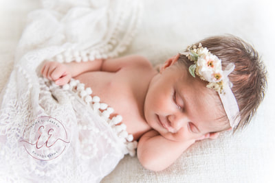 baby girl in lace and headband. Newborn photography in St Neots, Huntingdon, Cambridgeshire