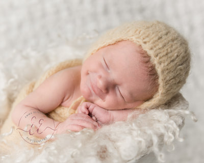 baby in knitted yellow hat. Newborn photography in St Neots, Huntingdon, Cambridgeshire